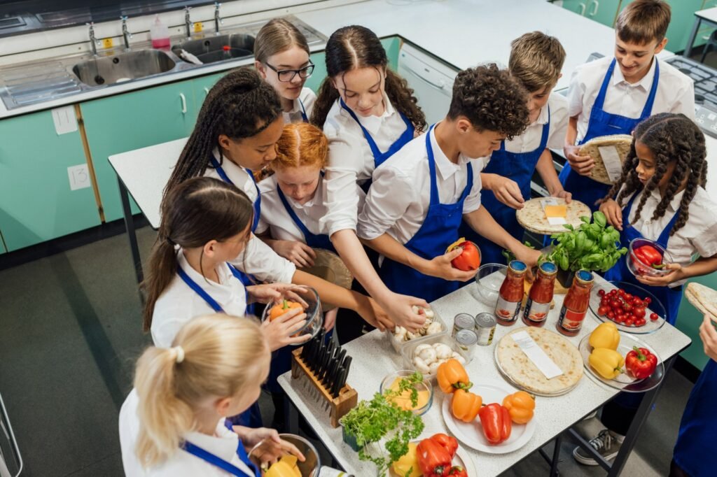 Group of teens working together to prepare a meal in a kitchen
